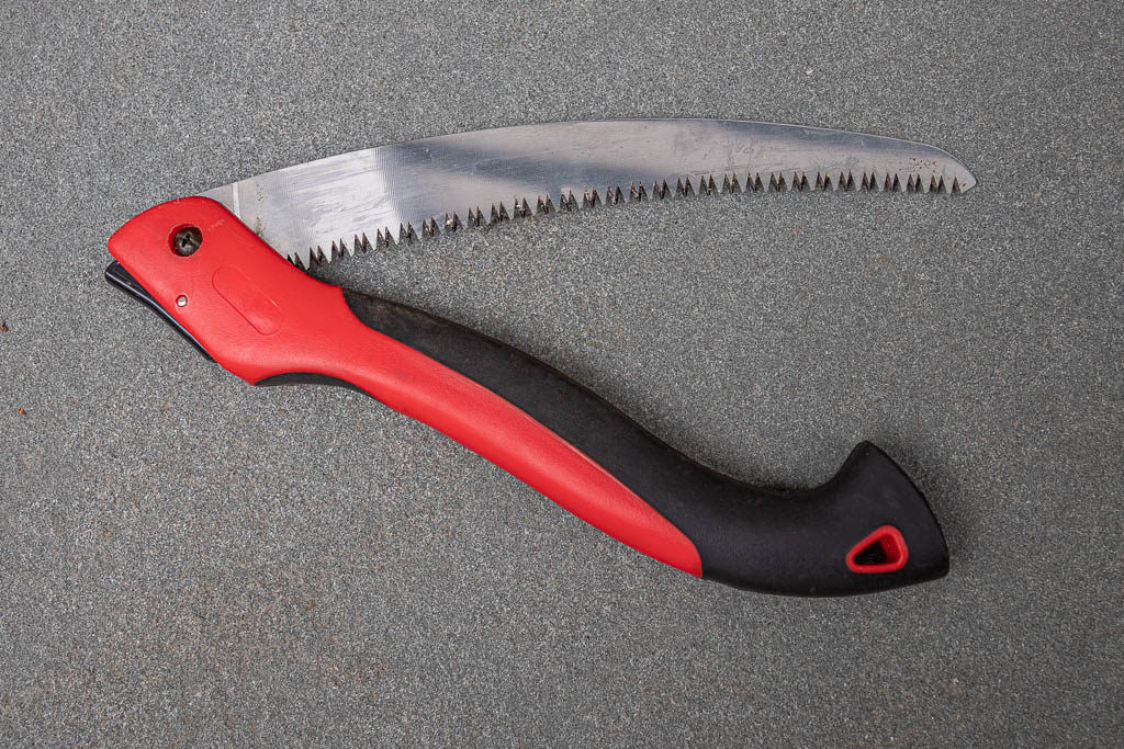 Partially folded red and black pruning saw